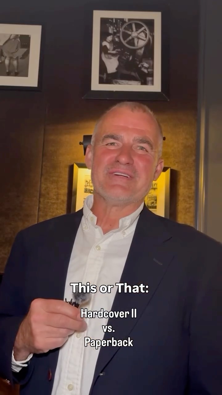 A man with a microphone in a CANREADS post asking Hardcover vs. Paperback.